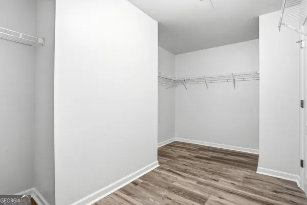 a view of a room with wooden floor