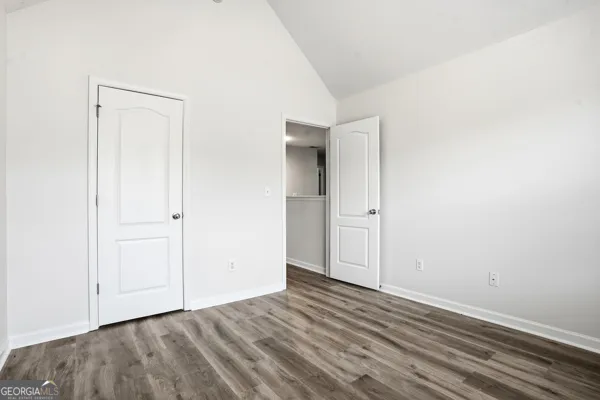 an empty room with wooden floor