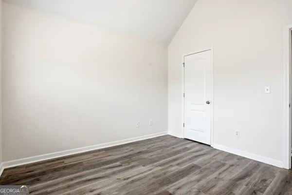 an empty room with wooden floor