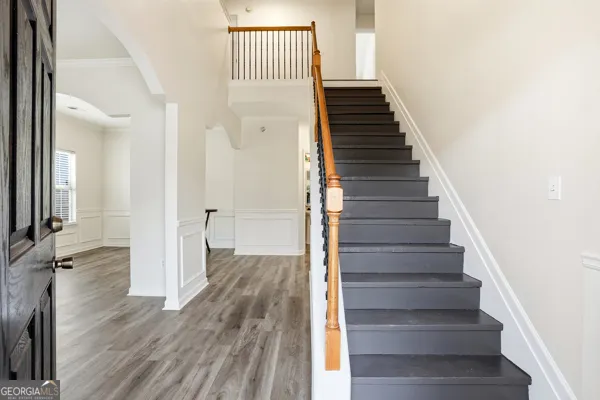 a view of a hallway with wooden floor and entryway