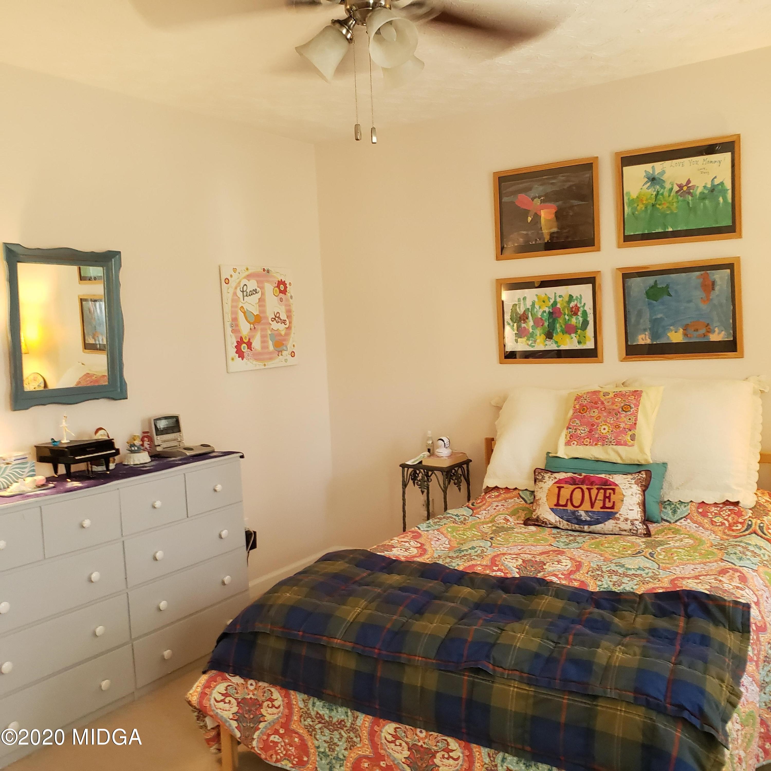 4969 Weaver Road Gainesville, GA 30507 - Photo 22 of 32 a bedroom with a bed and a painting on the wall