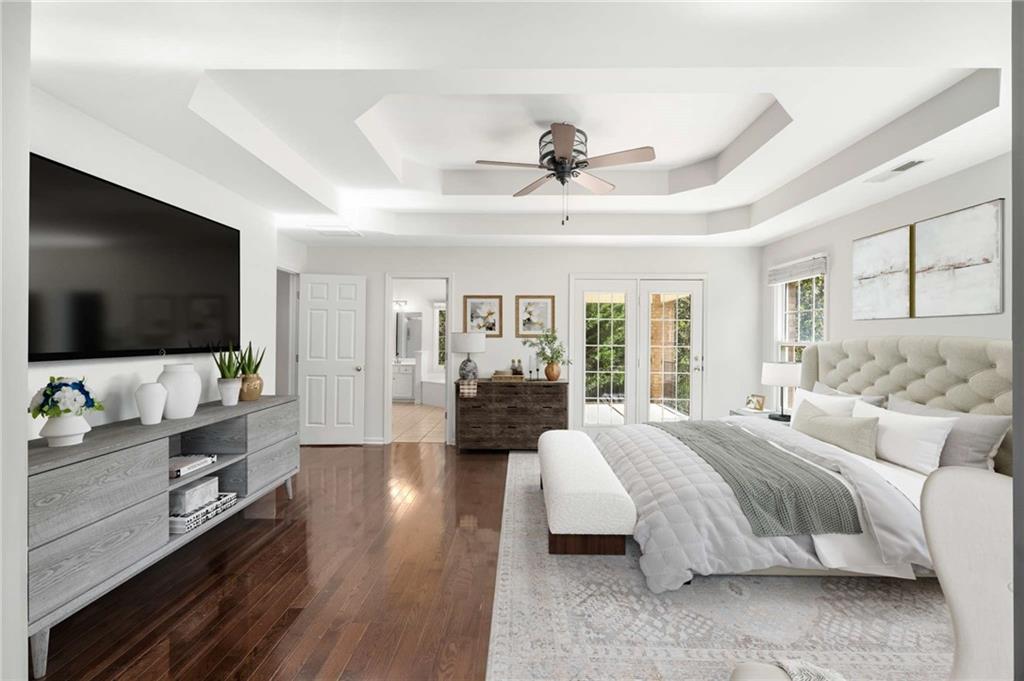 4200 Cherry Grove Road Ball Ground, GA 30107 - Photo 28 of 64 a spacious bedroom with a bed and a flat screen television