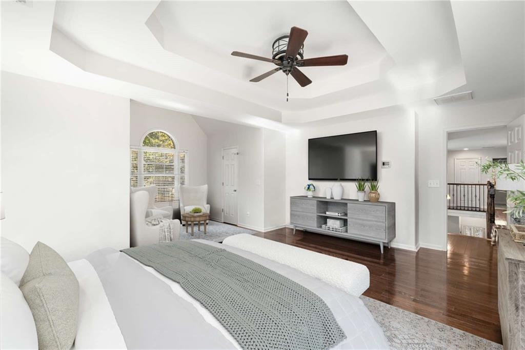 4200 Cherry Grove Road Ball Ground, GA 30107 - Photo 29 of 64 a bedroom with a bed a flat screen tv and a chandelier