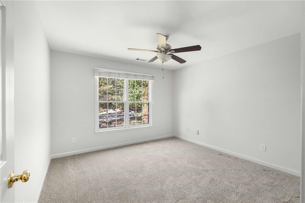 4200 Cherry Grove Road Ball Ground, GA 30107 - Photo 38 of 64 an empty room with a ceiling fan and window