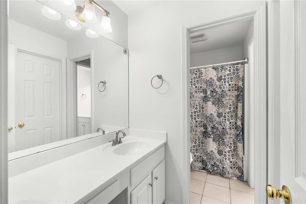 4200 Cherry Grove Road Ball Ground, GA 30107 - Photo 39 of 64 a bathroom with a double vanity sink and mirror
