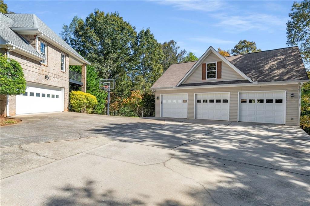 4200 Cherry Grove Road Ball Ground, GA 30107 - Photo 58 of 64 a front view of a house with a yard and garage