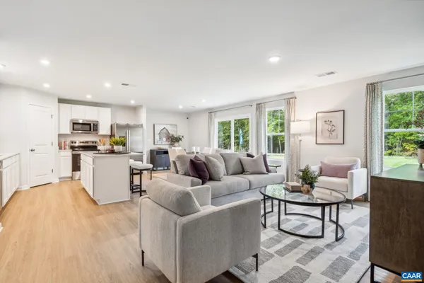 a living room with furniture a bathtub and a chandelier