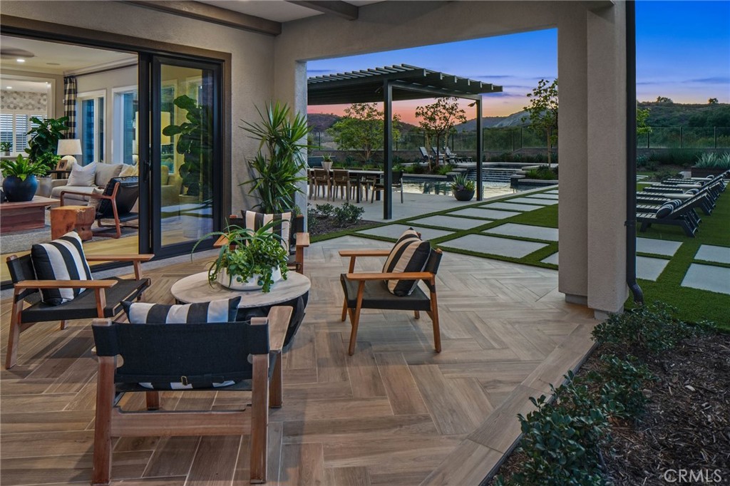 18295 Saddle Crest Silverado, CA 92676 - Photo 21 of 26 a view of a patio with a dining table and chairs