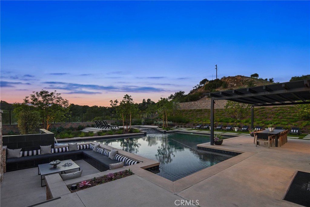 18295 Saddle Crest Silverado, CA 92676 - Photo 23 of 26 a view of a swimming pool and lounge chairs in patio