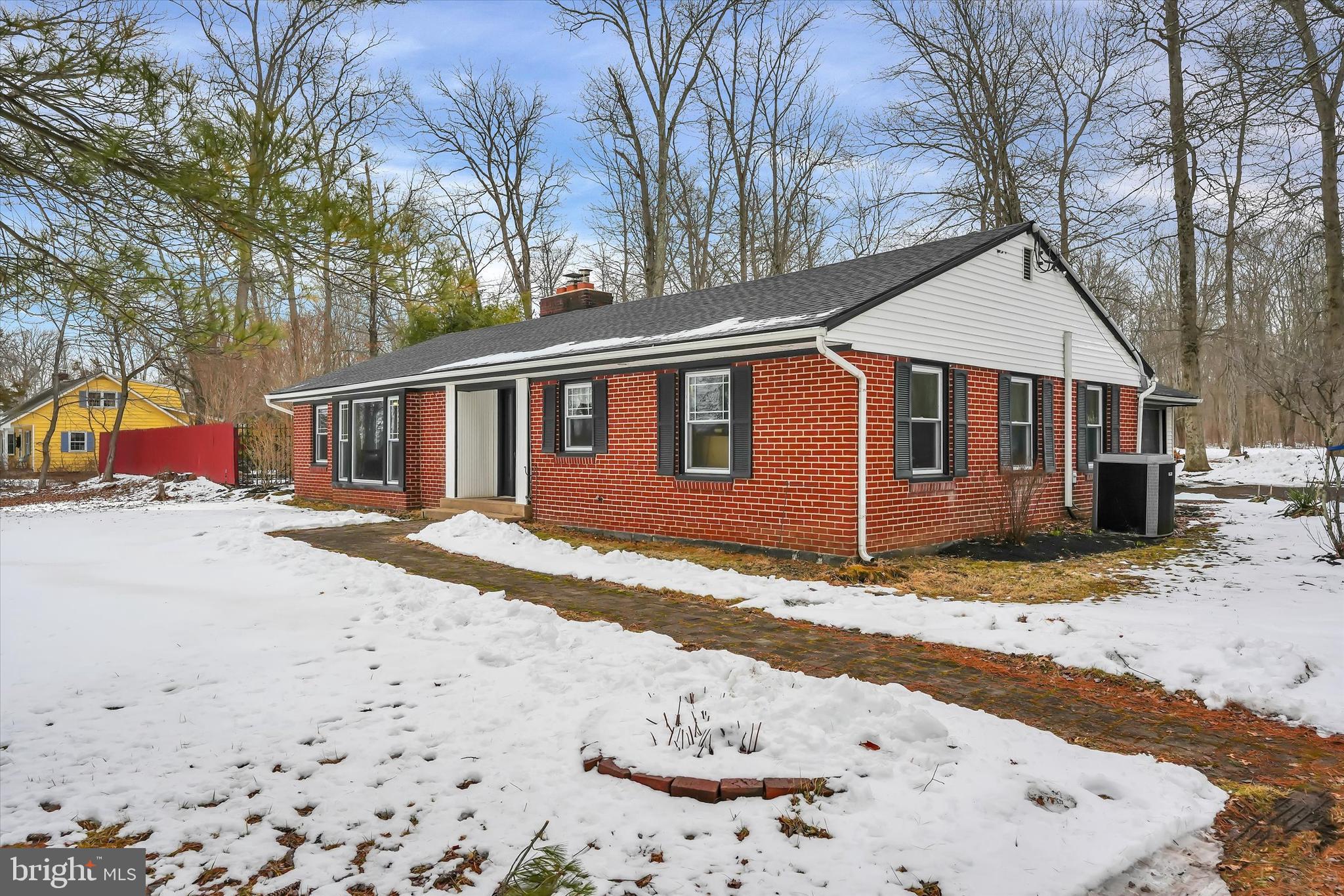 a view of a large white house with a snow on the road