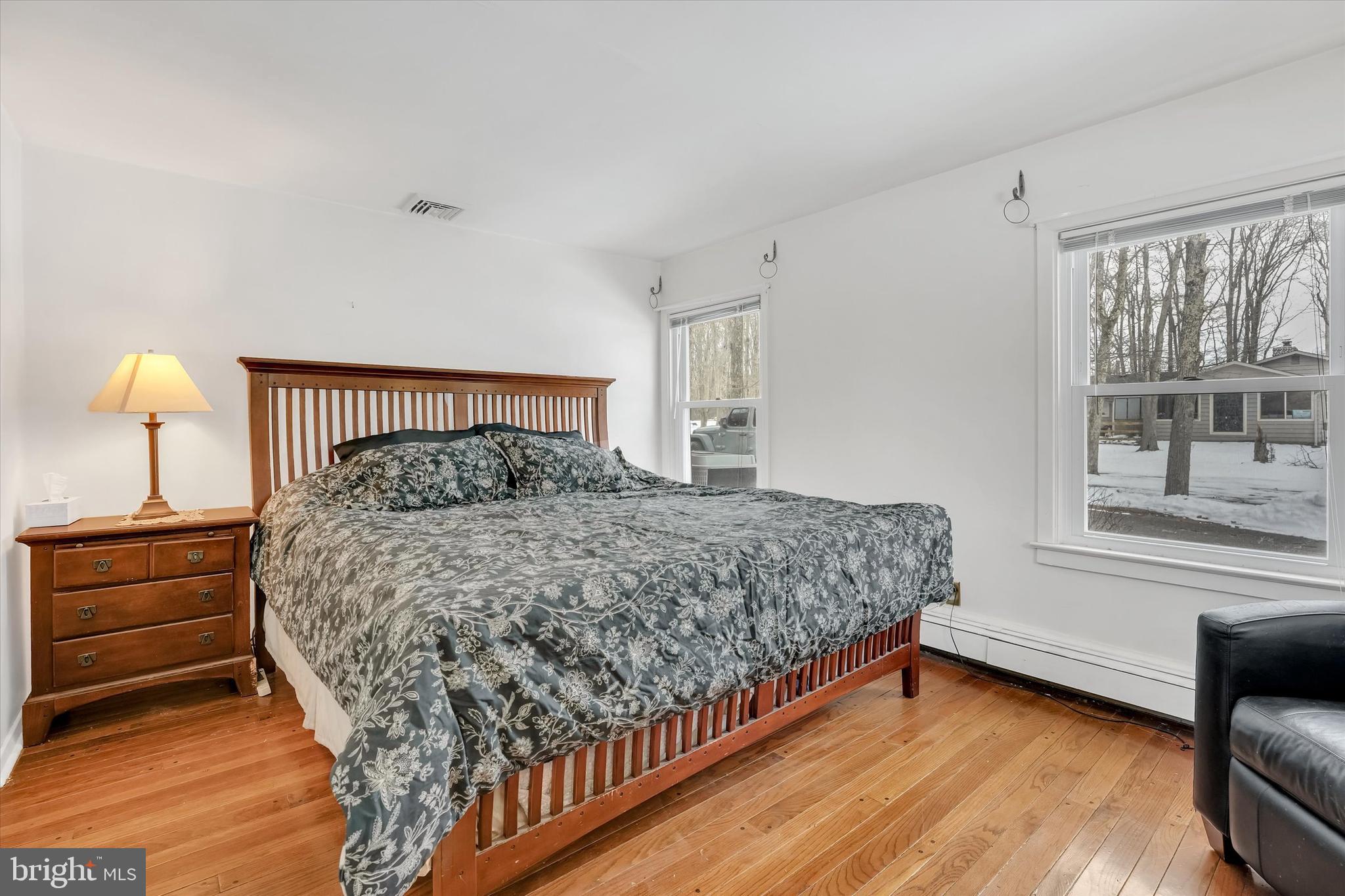 6246 Point Pleasant Pike Doylestown, PA 18902 - Photo 14 of 40 a bedroom with a bed and wooden floor