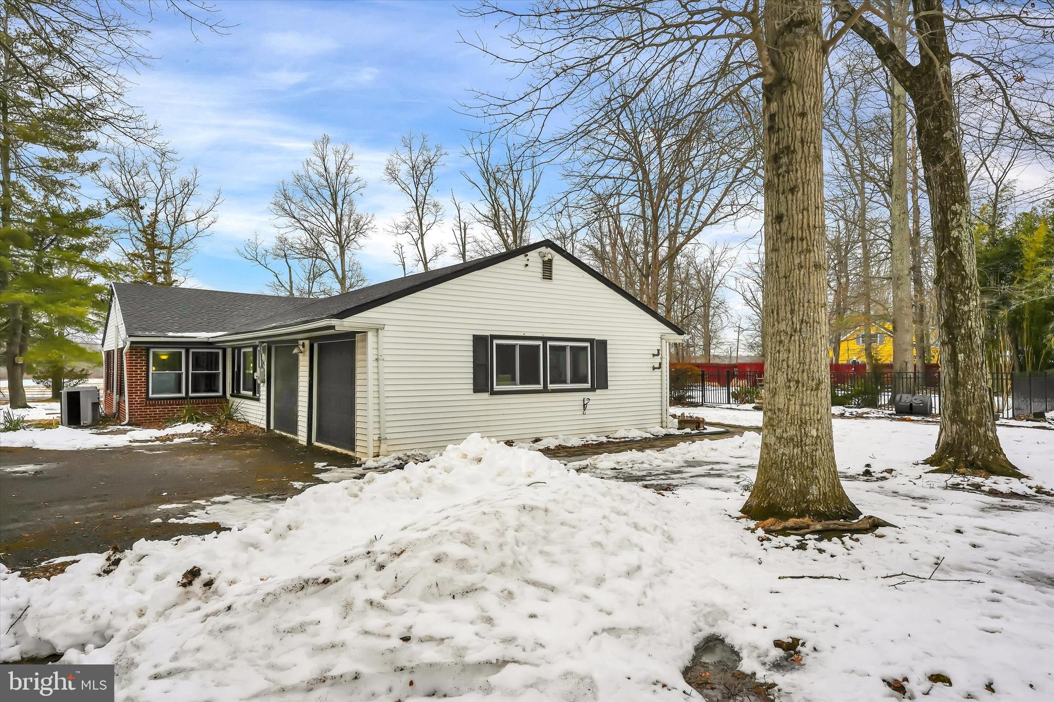 6246 Point Pleasant Pike Doylestown, PA 18902 - Photo 29 of 40 a front view of a house with a yard covered in snow