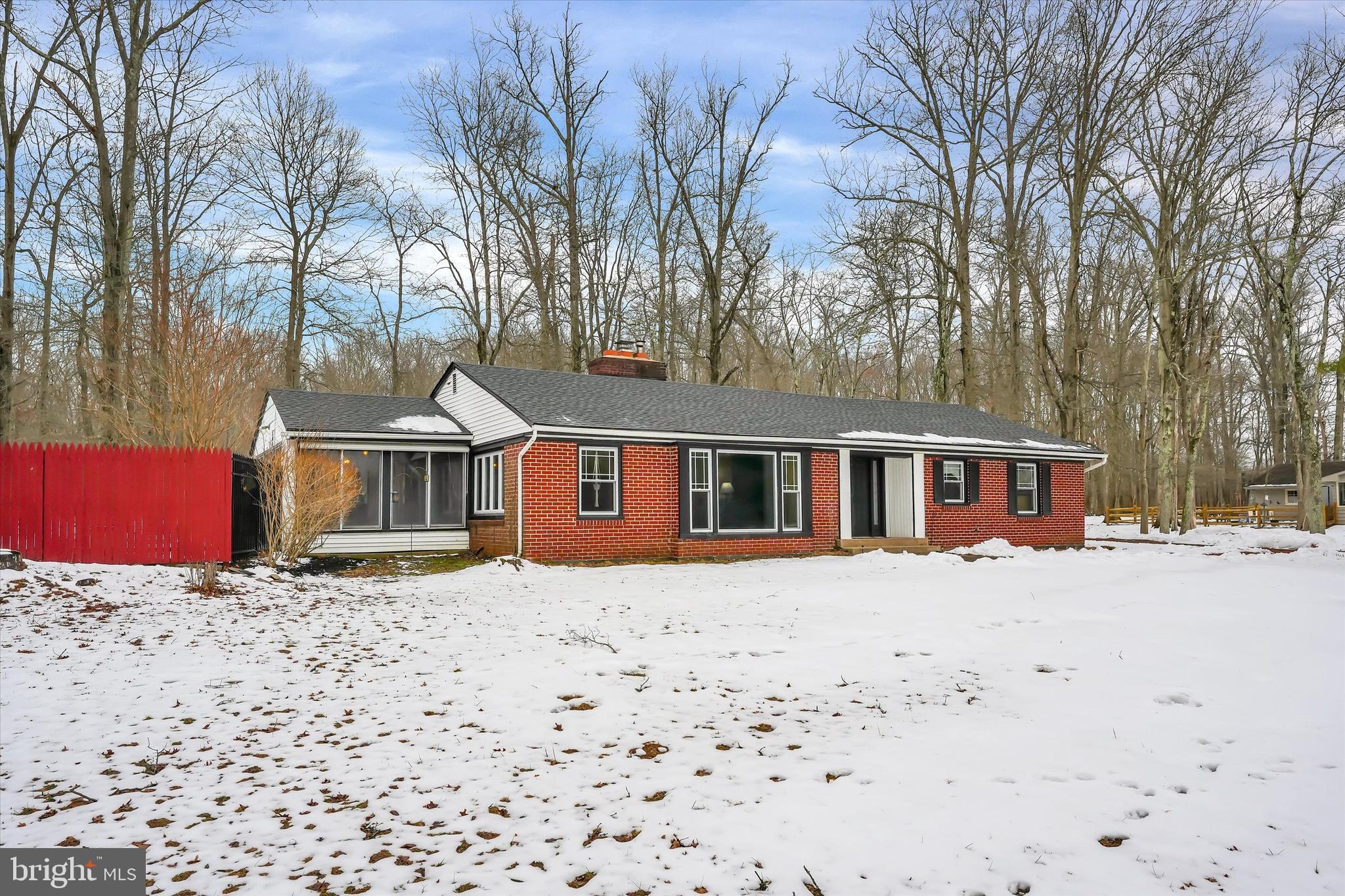 6246 Point Pleasant Pike Doylestown, PA 18902 - Photo 3 of 40 a front view of a house with a yard covered in snow