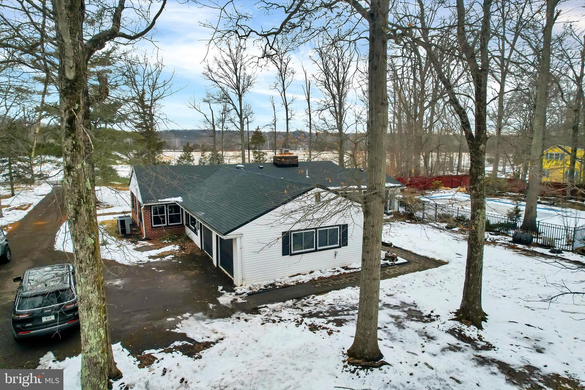 6246 Point Pleasant Pike Doylestown, PA 18902 - Photo 35 of 40 a front view of a house with a yard covered in snow