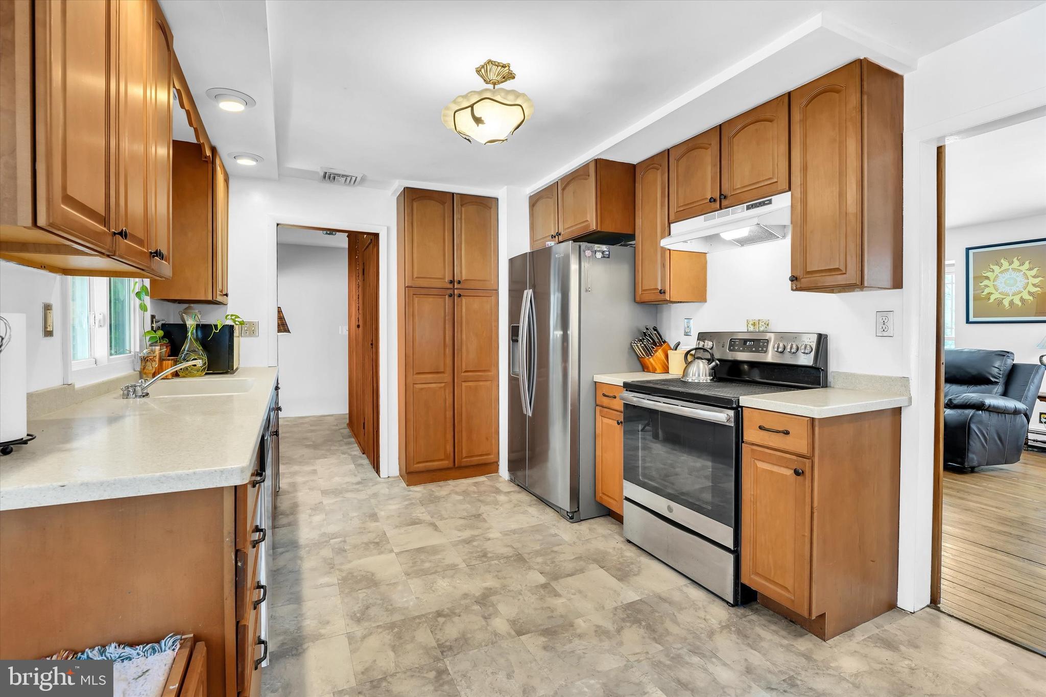 6246 Point Pleasant Pike Doylestown, PA 18902 - Photo 10 of 40 a kitchen with stainless steel appliances granite countertop a refrigerator a stove a sink and a microwave