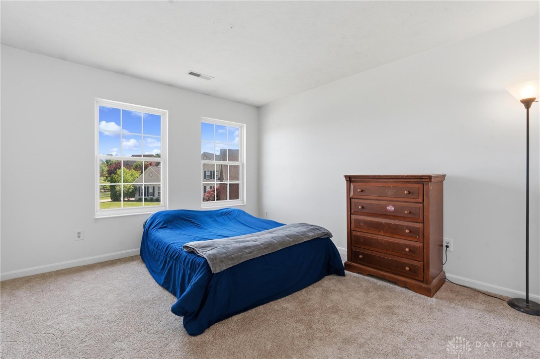 70 Martin Lane Springboro, OH 45066 - Photo 31 of 69 This cozy bedroom features bright windows overlooking the neighborhood and soft carpeting underfoot.
