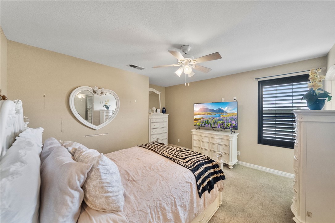 6920 Channel Court Eastvale, CA 91752 - Photo 15 of 57 a bedroom with a bed and a chandelier