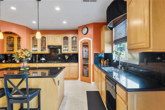 a kitchen with stainless steel appliances granite countertop a sink and cabinets