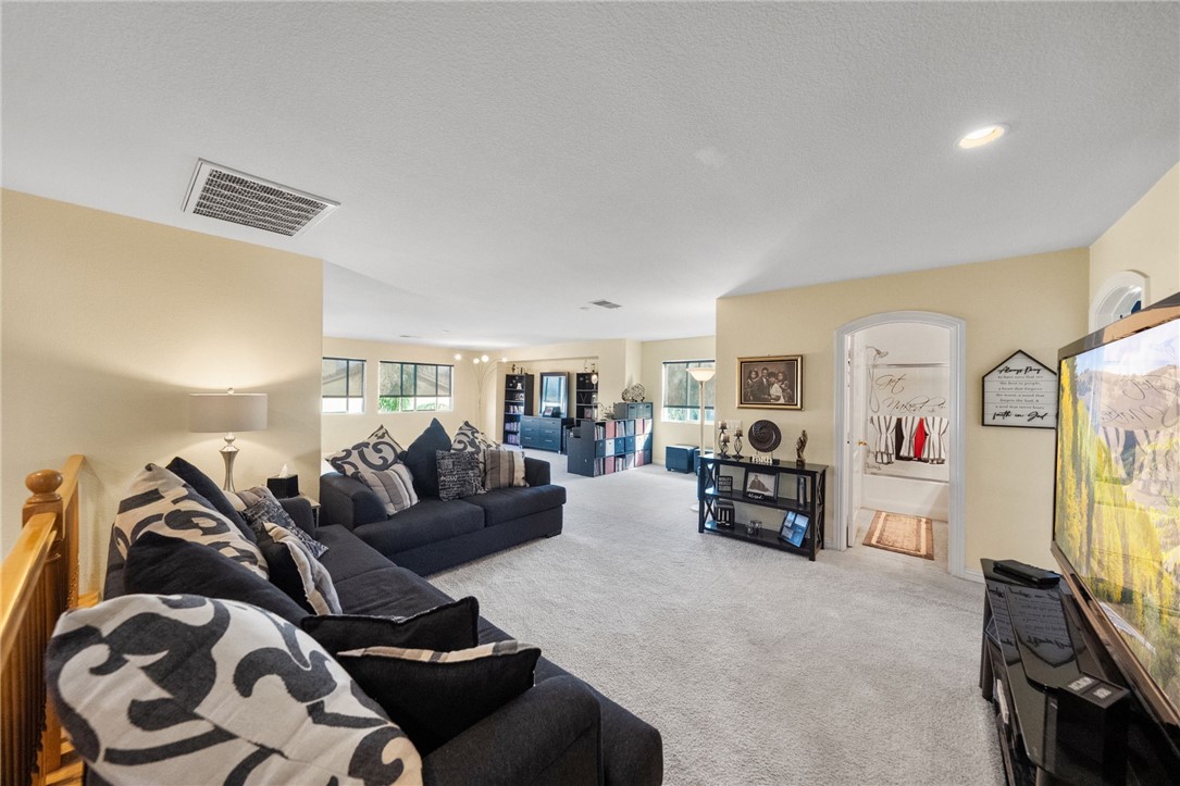 6920 Channel Court Eastvale, CA 91752 - Photo 24 of 57 a living room with furniture and a flat screen tv