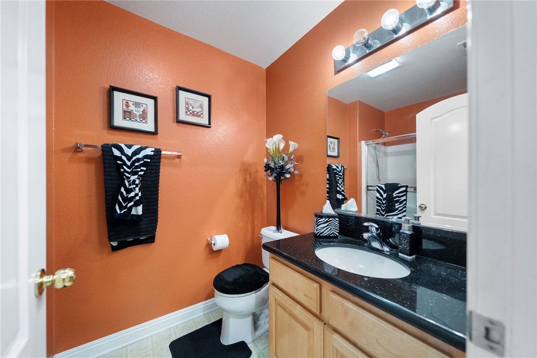 6920 Channel Court Eastvale, CA 91752 - Photo 25 of 57 a bathroom with a sink and a mirror