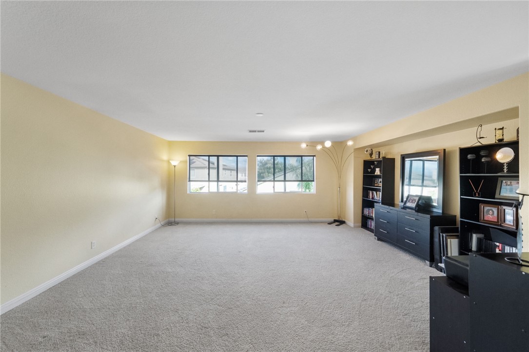 6920 Channel Court Eastvale, CA 91752 - Photo 29 of 57 an empty room with bookshelf and a window
