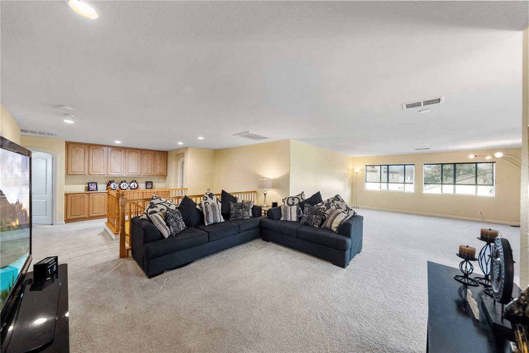 6920 Channel Court Eastvale, CA 91752 - Photo 30 of 57 a living room with furniture and a large window