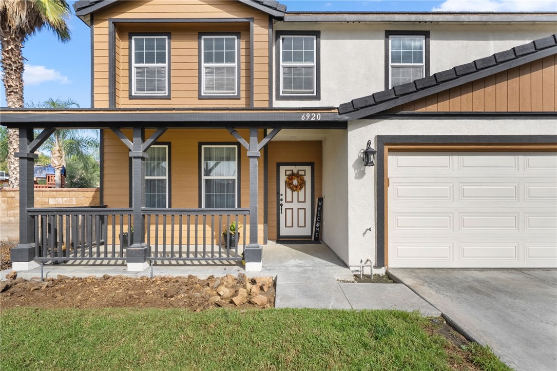 6920 Channel Court Eastvale, CA 91752 - Photo 3 of 57 a front view of a house with a garden