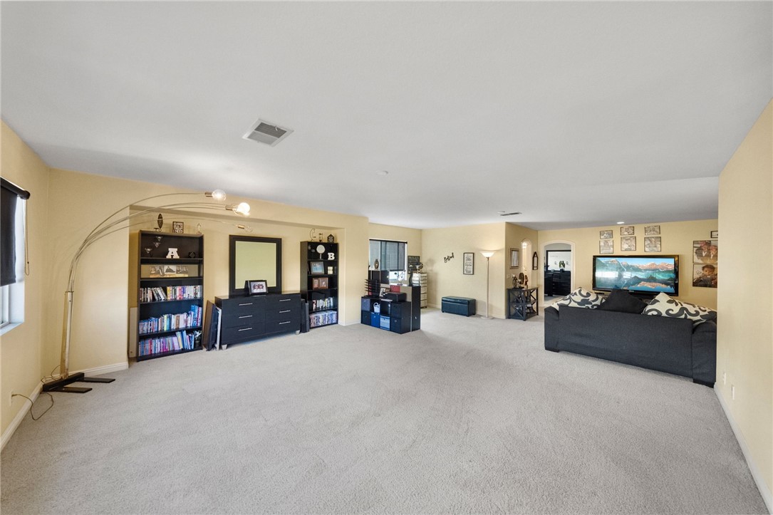 6920 Channel Court Eastvale, CA 91752 - Photo 32 of 57 a living room with furniture and a large window