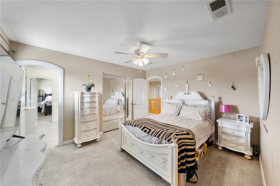6920 Channel Court Eastvale, CA 91752 - Photo 36 of 57 a bedroom with a bed and a chandelier