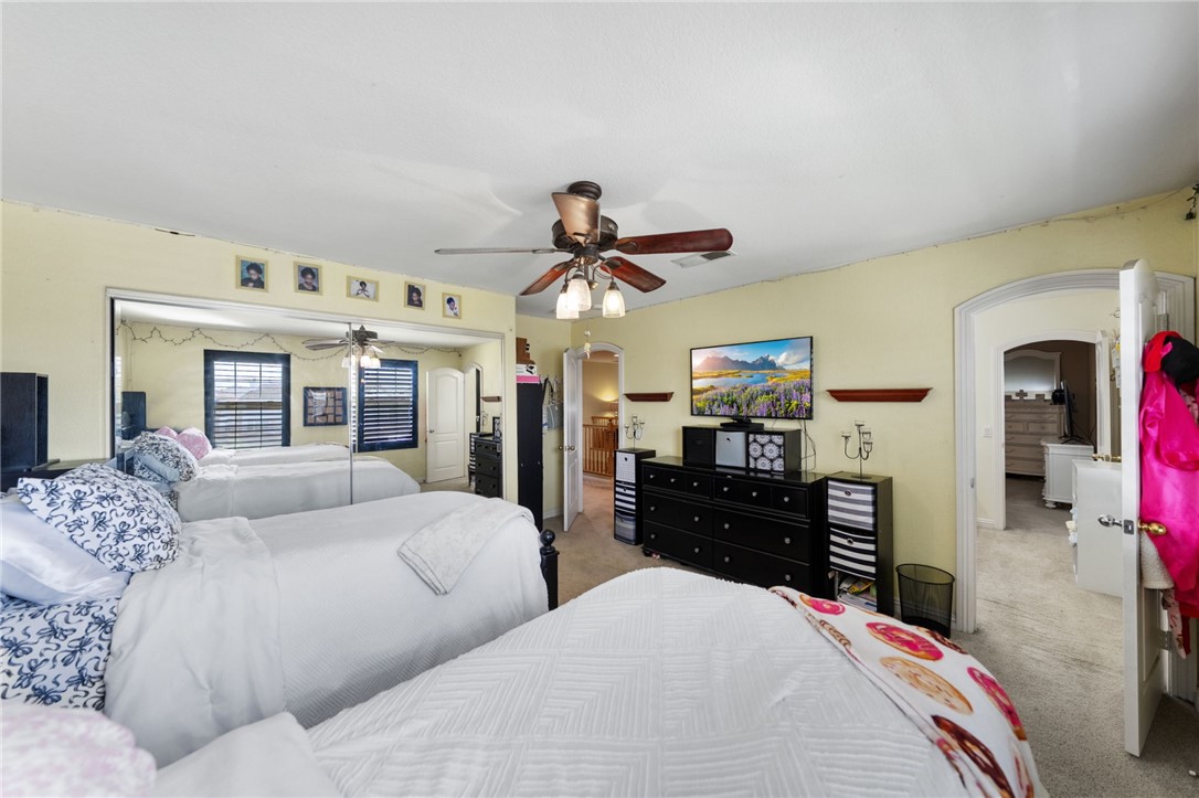 6920 Channel Court Eastvale, CA 91752 - Photo 38 of 57 a living room with furniture a chandelier and a flat screen tv