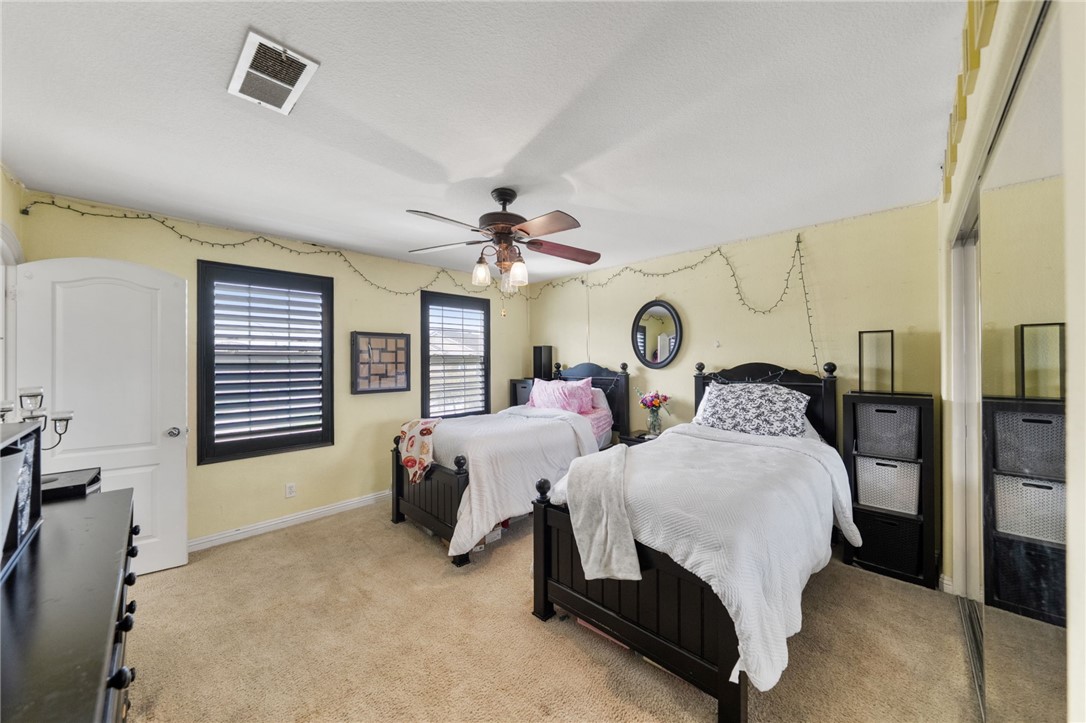 6920 Channel Court Eastvale, CA 91752 - Photo 39 of 57 a bedroom with bed and a chandelier