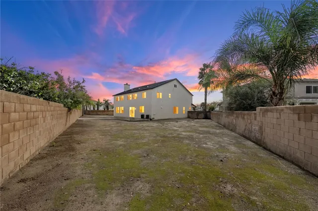 a view of a house with wooden fence
