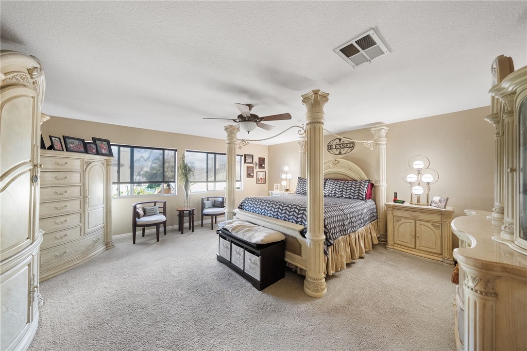 6920 Channel Court Eastvale, CA 91752 - Photo 41 of 57 a bedroom with a bed couch and a window