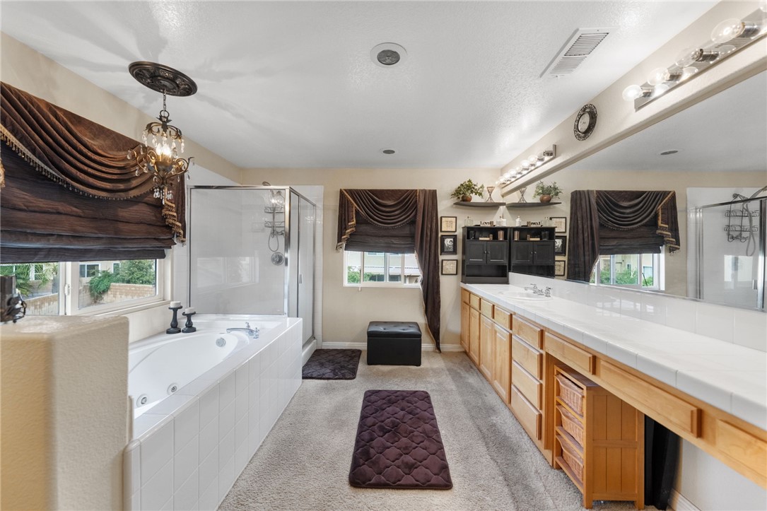 6920 Channel Court Eastvale, CA 91752 - Photo 43 of 57 a large white kitchen with a large window