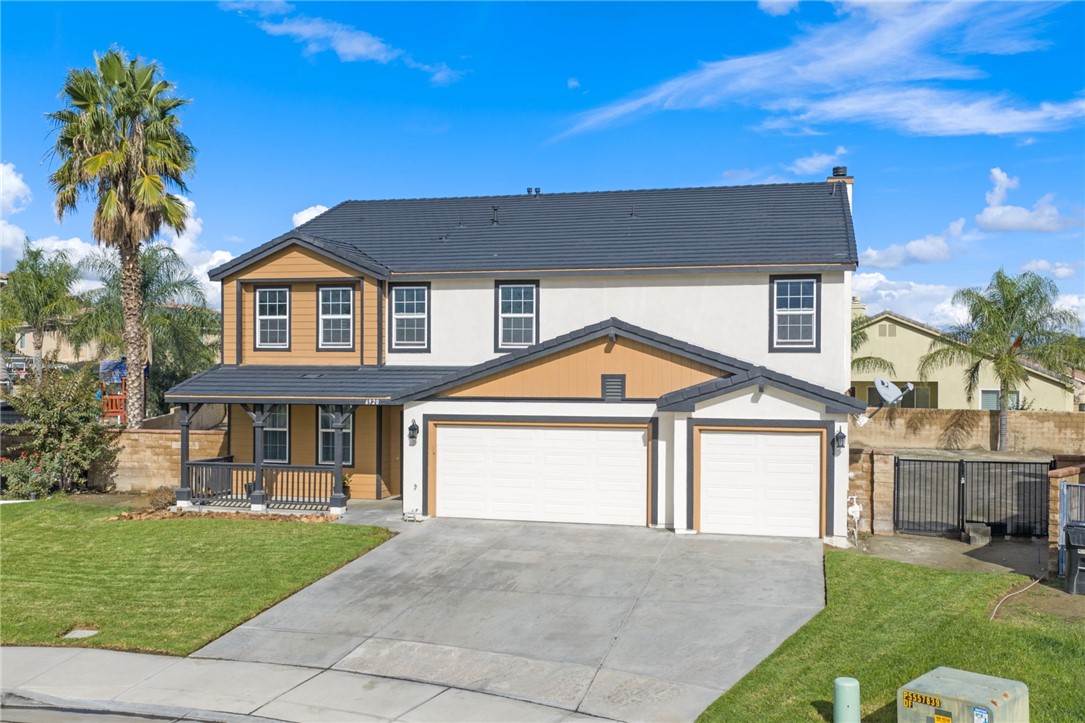 6920 Channel Court Eastvale, CA 91752 - Photo 47 of 57 a front view of a house with a garden and yard