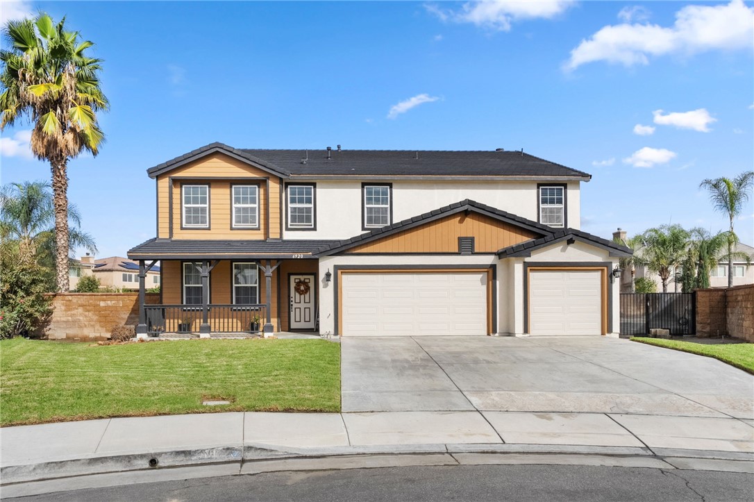 6920 Channel Court Eastvale, CA 91752 - Photo 49 of 57 a front view of a house with a yard and garage