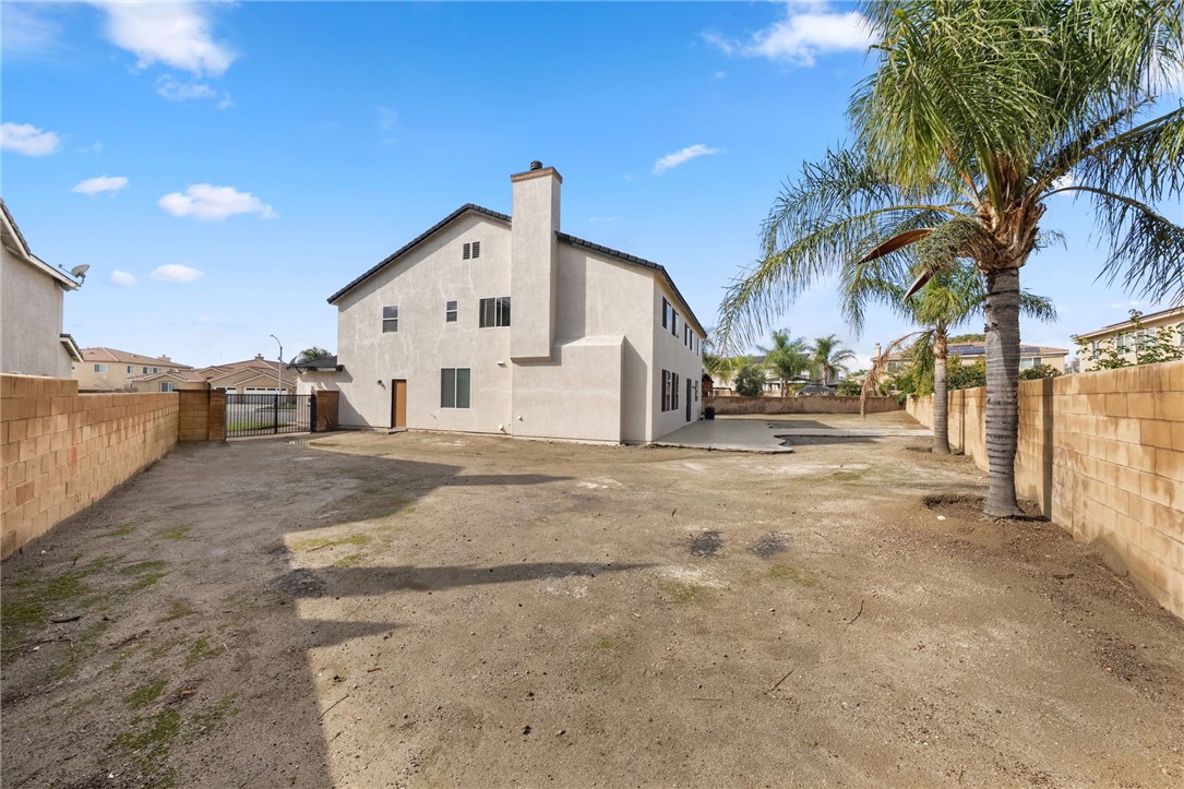 6920 Channel Court Eastvale, CA 91752 - Photo 53 of 57 a view of a white house with a large space and palm trees