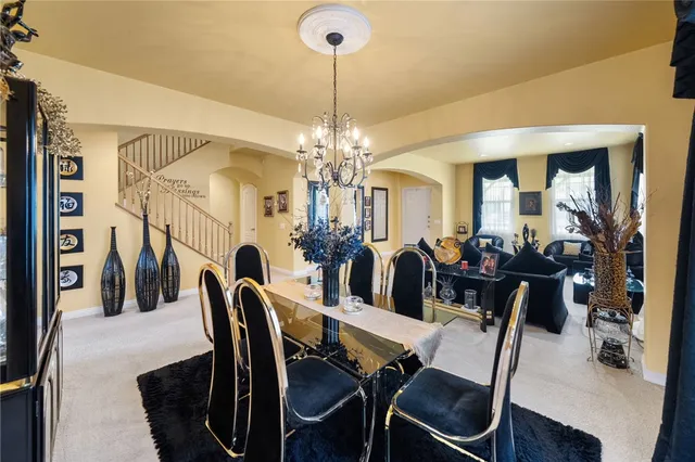 a view of a dining room with furniture and chandelier