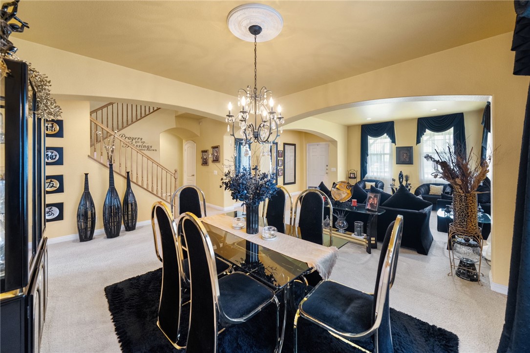 6920 Channel Court Eastvale, CA 91752 - Photo 9 of 57 a view of a dining room with furniture and chandelier