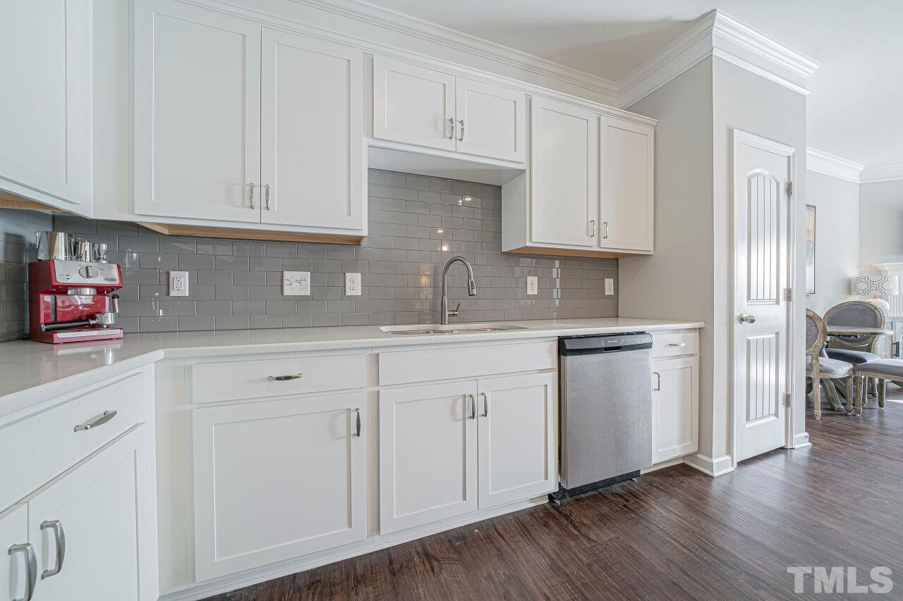 6343 Grace Lily Drive Raleigh, NC 27607 - Photo 8 of 24 a kitchen with white cabinets and sink
