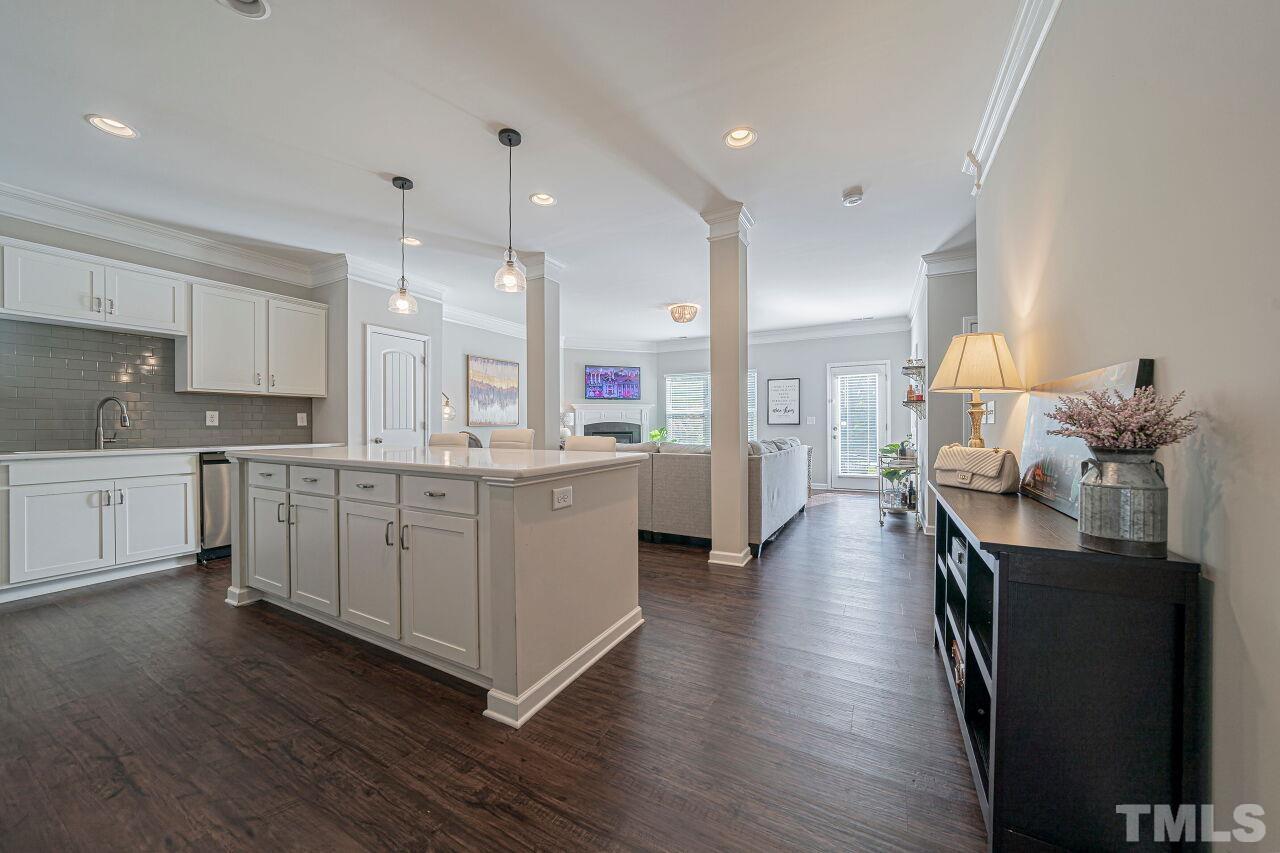 6343 Grace Lily Drive Raleigh, NC 27607 - Photo 9 of 24 a kitchen with kitchen island cabinets and wooden floor