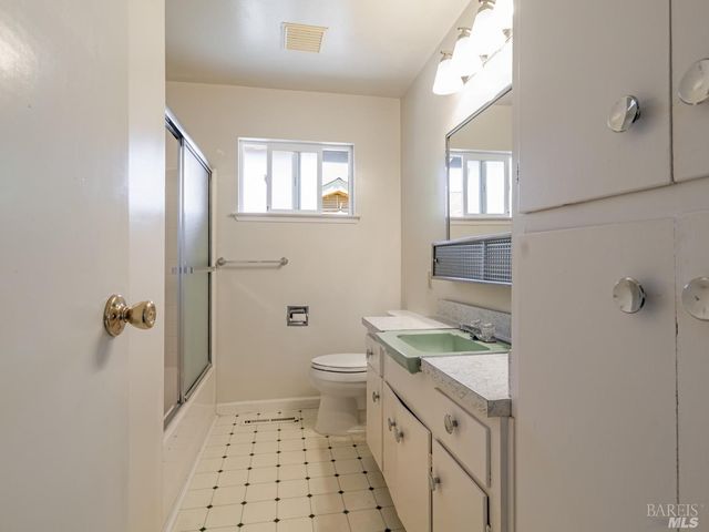 a bathroom with a glass shower door