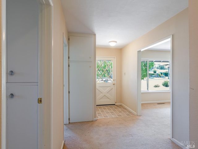 an empty room with windows and closet