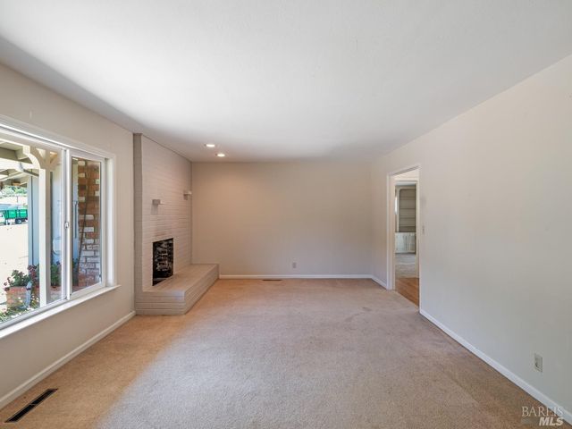 a kitchen with granite countertop a sink a stove and refrigerator