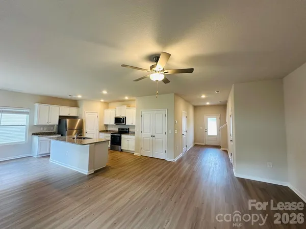 a view of a kitchen with a sink and a stove top oven