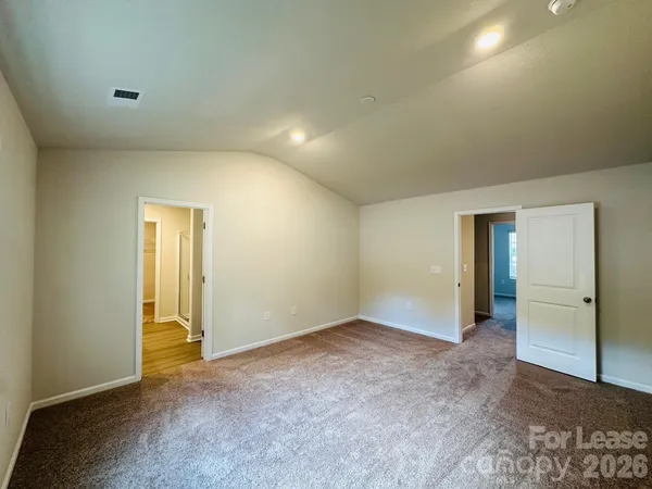 an empty room with closet and wooden door