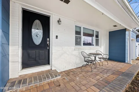 a view of a door and chair in the back yard of a house