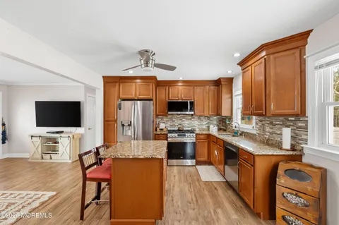 a kitchen with stainless steel appliances granite countertop a stove a sink dishwasher and a microwave