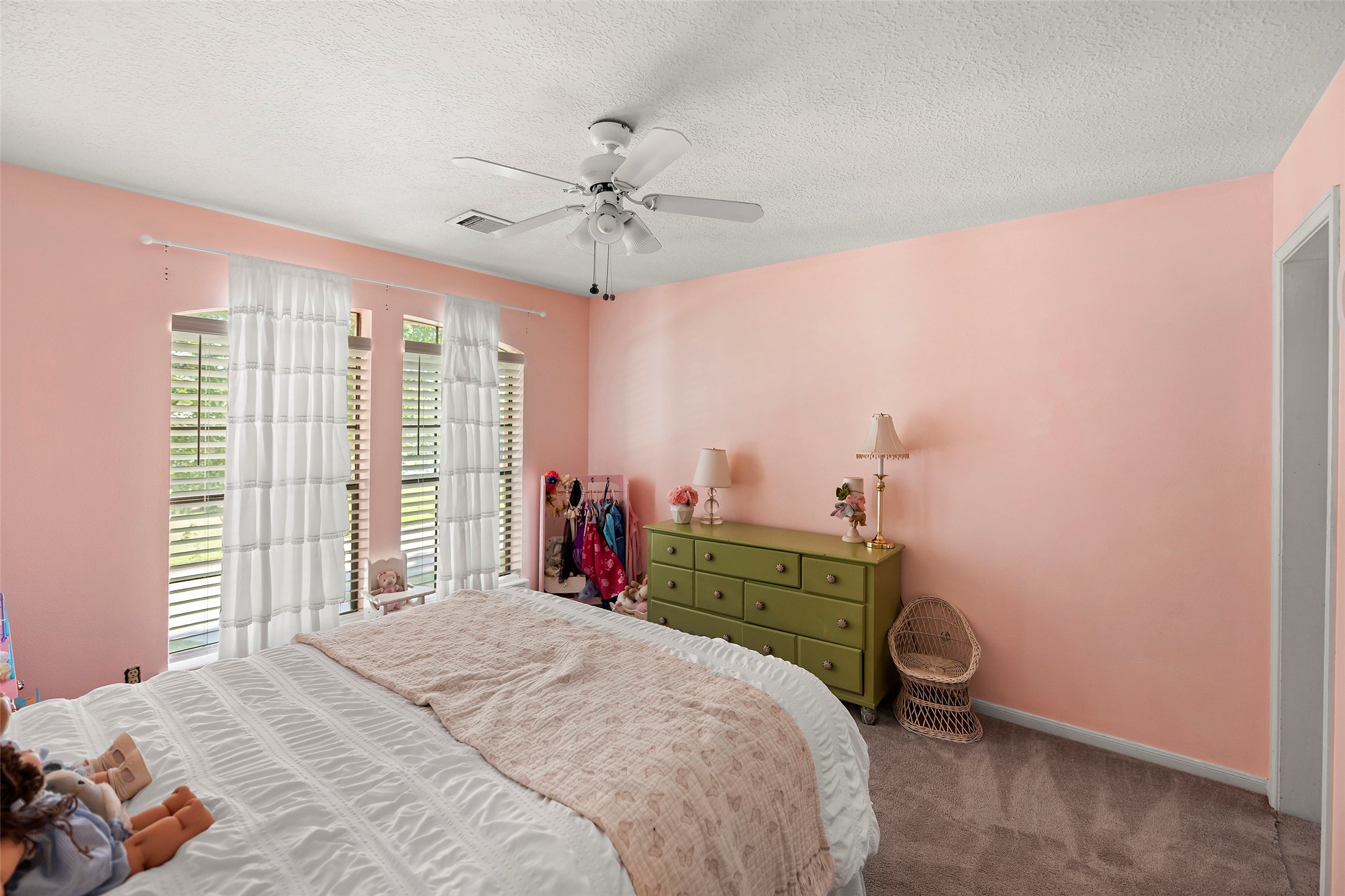 17607 Terrawren Lane Spring, TX 77379 - Photo 22 of 32 a bedroom with a bed and a chandelier