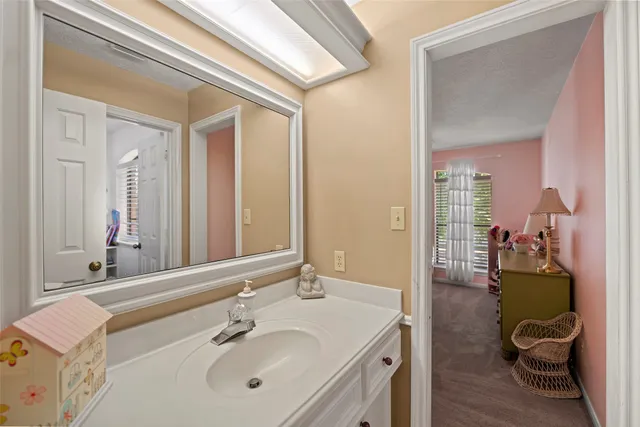 a en suite bathroom with a sink and a mirror